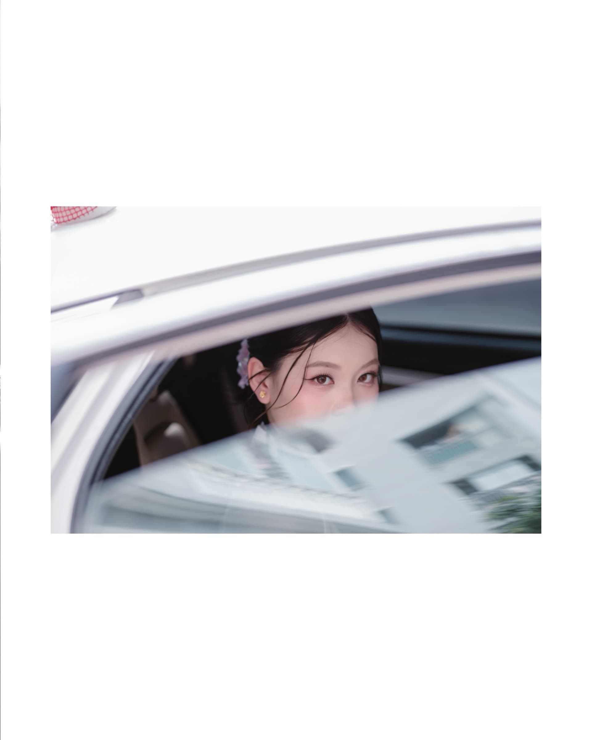 A bride looking through the window of a wedding car